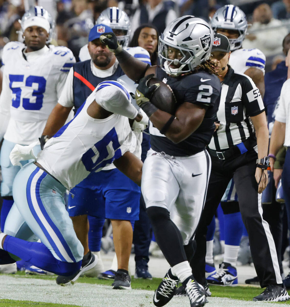 Raiders running back Ashton Jeanty (2) is pushed out of bound by Dallas Cowboys linebacker Shem ...