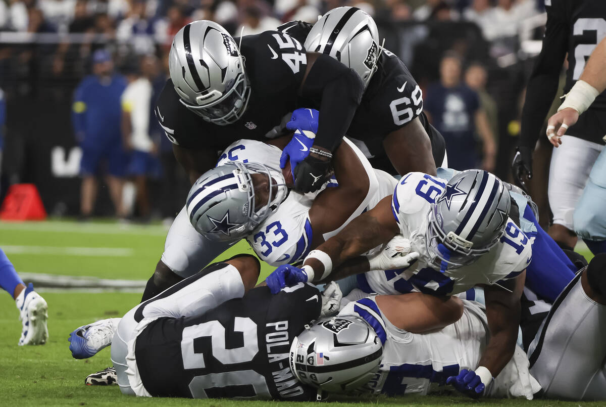 Raiders linebacker Devin White (45) tackles Dallas Cowboys running back Javonte Williams (33) d ...