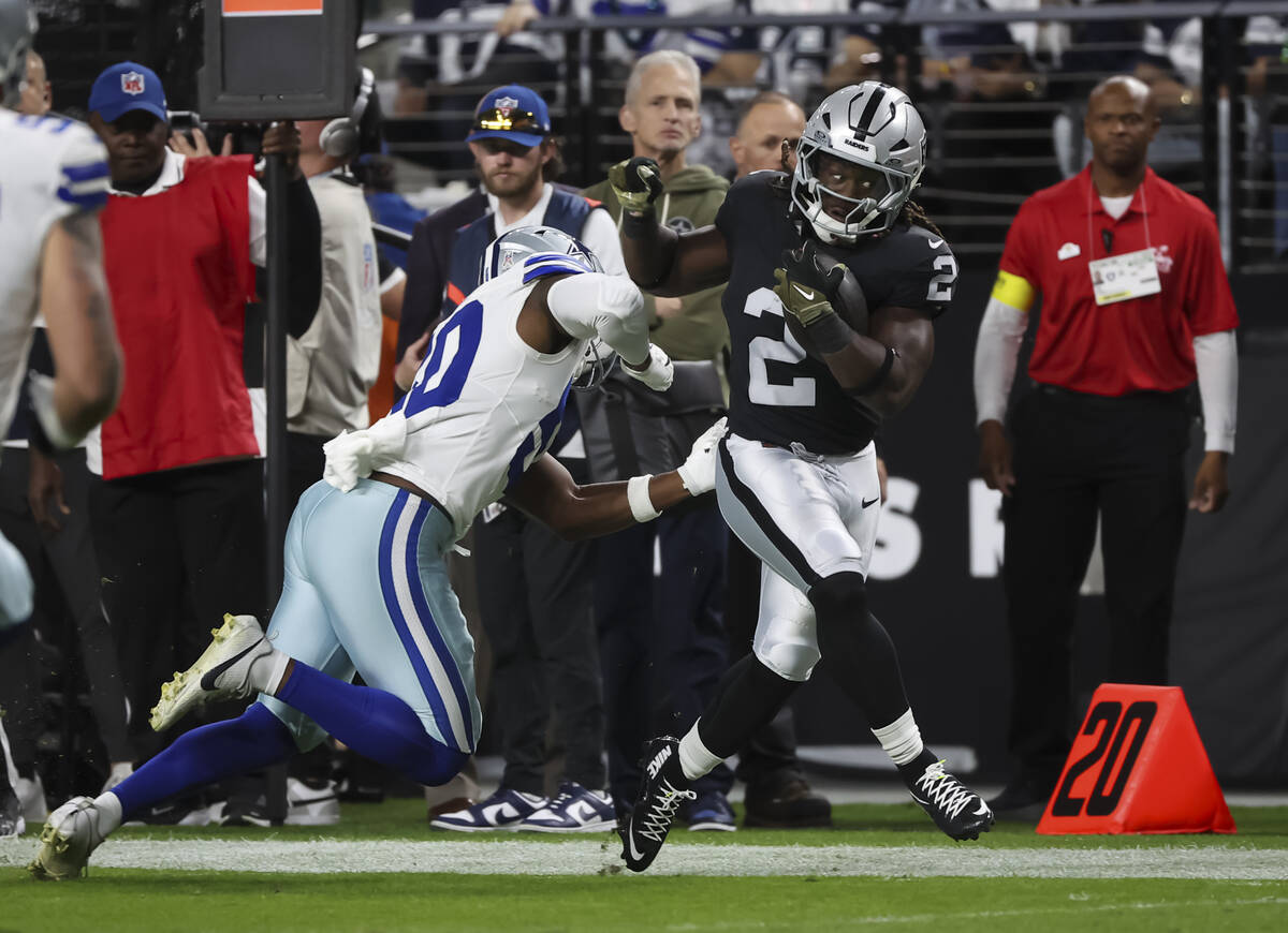 Raiders running back Ashton Jeanty (2) gets forced out of bounds by Dallas Cowboys linebacker S ...