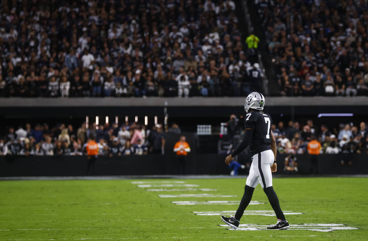 Raiders quarterback Geno Smith (7) walks off the field after a third-down sack by the Dallas Co ...