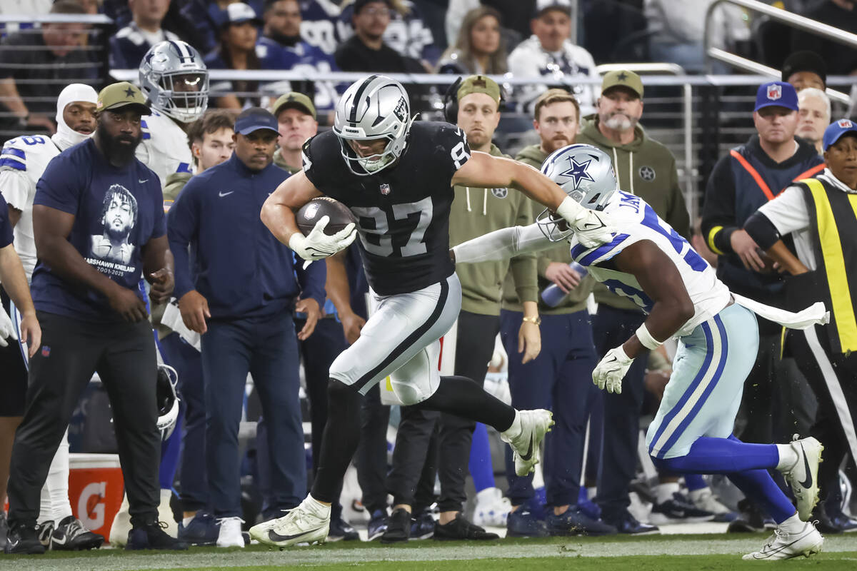 Raiders tight end Michael Mayer (87) runs the ball under pressure from Dallas Cowboys linebacke ...