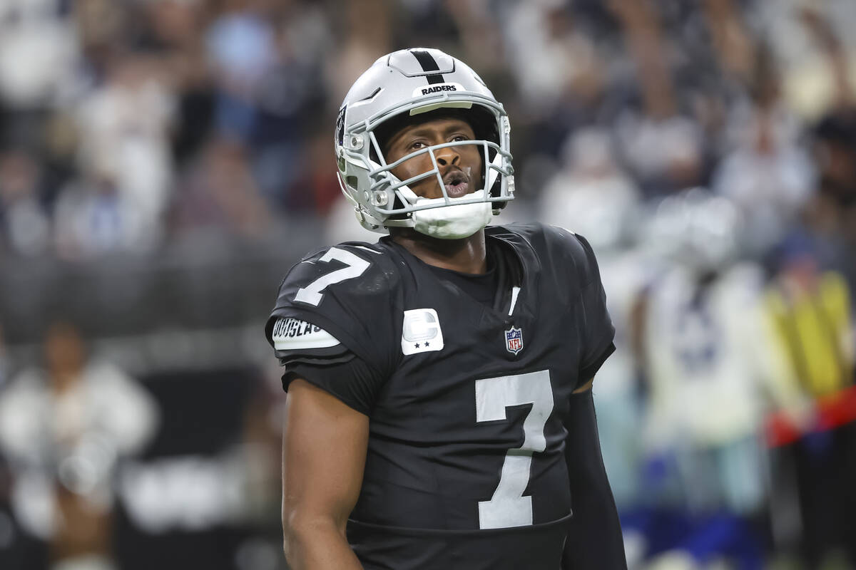 Raiders quarterback Geno Smith (7) walks off the field after getting sacked in the final moment ...