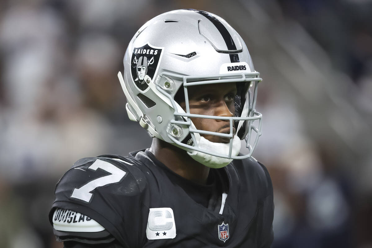 Raiders quarterback Geno Smith (7) walks off the field after getting sacked in the final moment ...