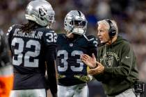 Raiders head coach Pete Carroll gives instruction to safety Lonnie Johnson (32) and linebacker ...