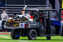 Utah State Aggies safety Titan Saxton (23) lifts a fist into the air as fans cheer, he injured ...