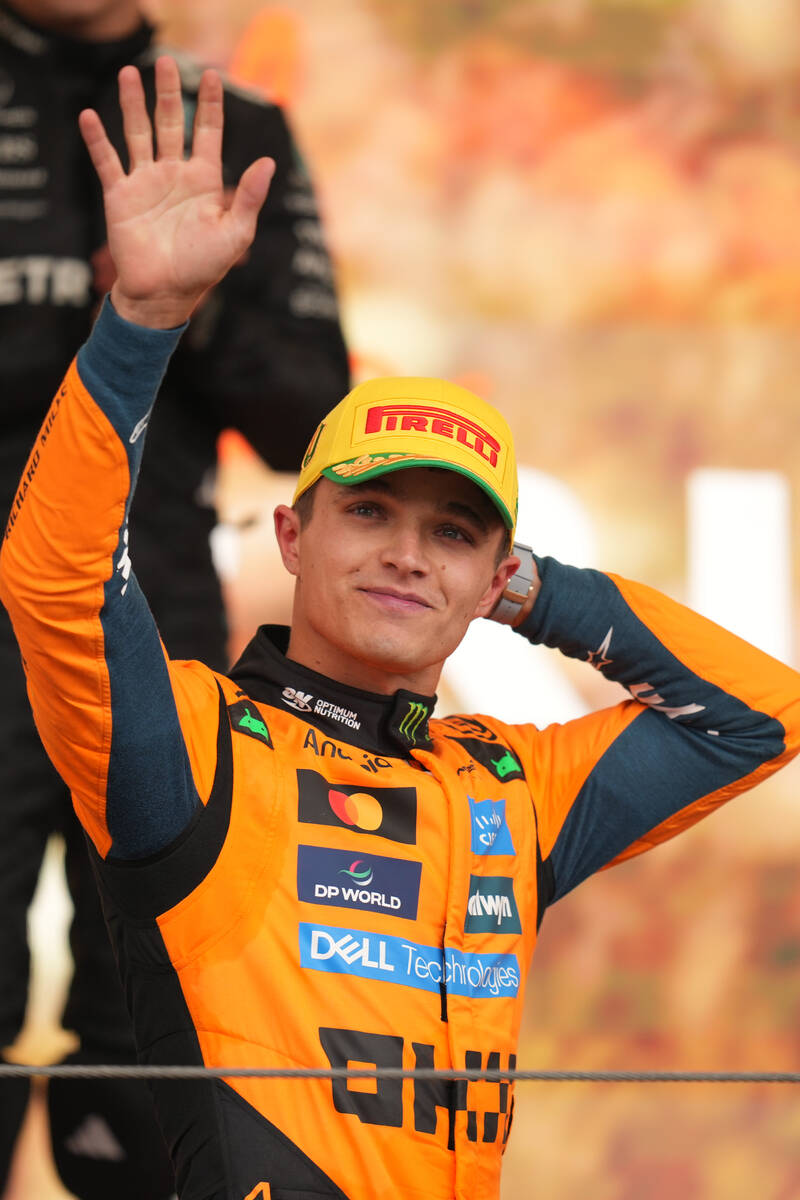McLaren driver Lando Norris of Britain celebrates on the podium his first place in the Brazilia ...