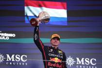 Red Bull driver Max Verstappen of the Netherlands celebrates on the podium his third place duri ...