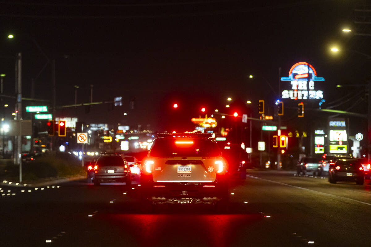 A Metropolitan Police Department officer with the Traffic Bureau drives along Boulder Highway o ...
