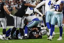 Raiders quarterback Geno Smith (7) gets sacked by the Dallas Cowboys during the first half of a ...