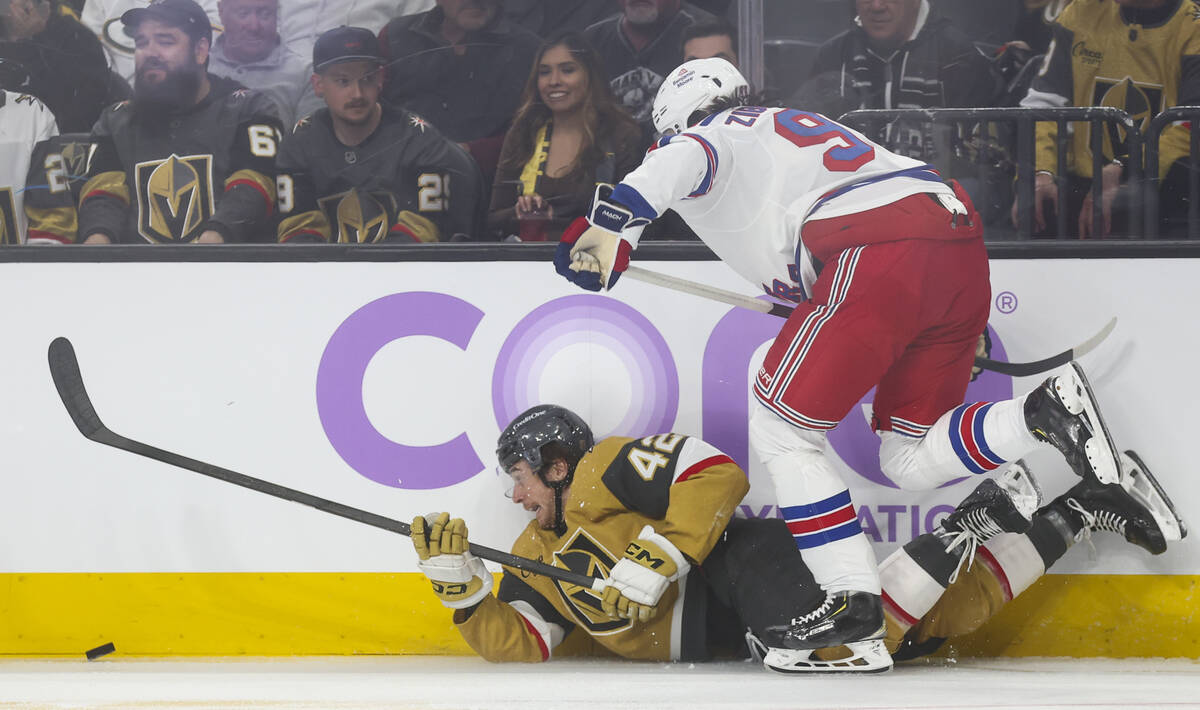 Golden Knights right wing Braeden Bowman (42) gets tripped up as New York Rangers center Mika Z ...
