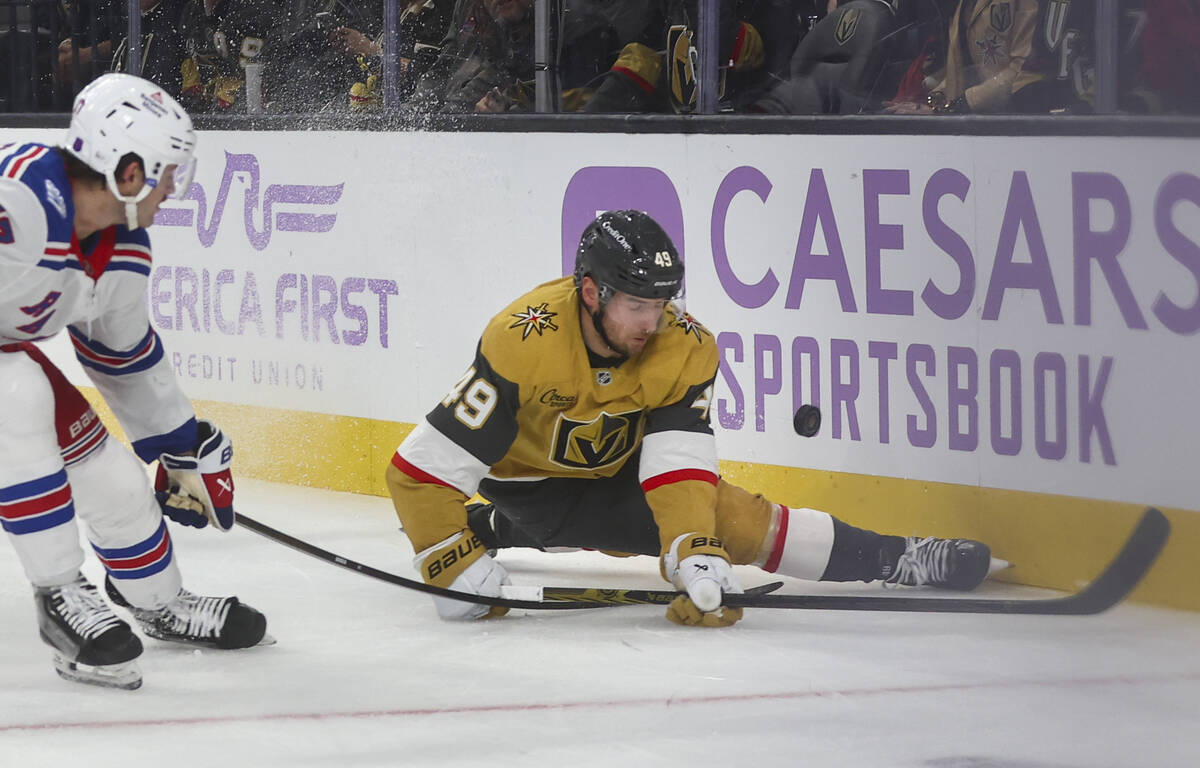 Golden Knights left wing Ivan Barbashev (49) slips to the ice under pressure from New York Rang ...