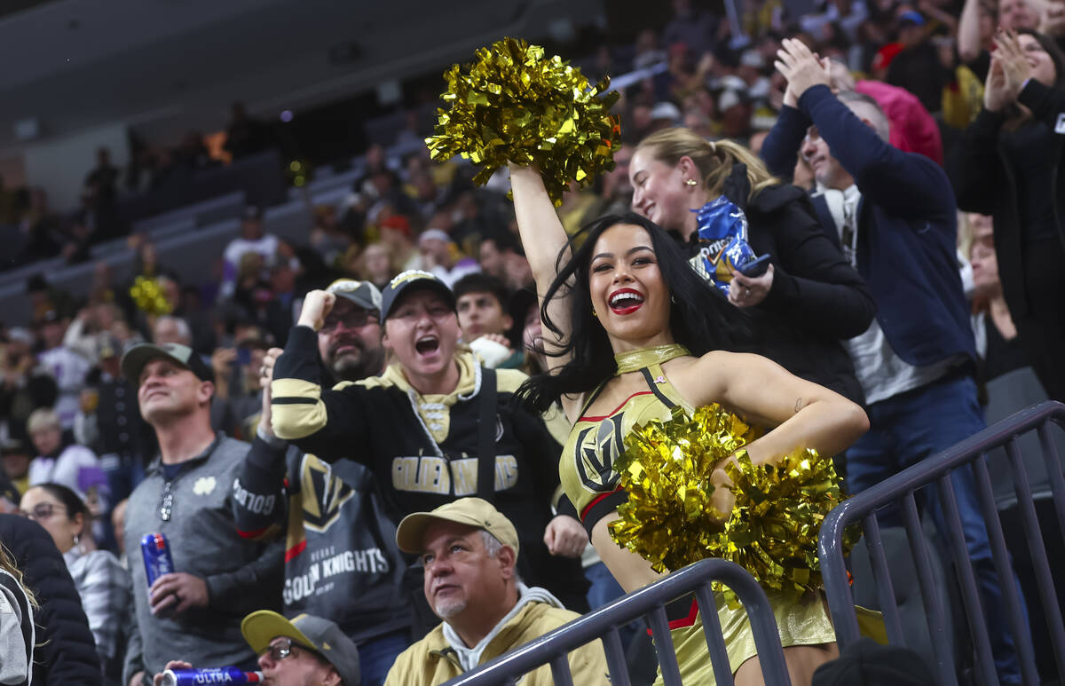 Golden Knights fans and a Vegas Vivas cheerleader celebrate a goal against the New York Rangers ...