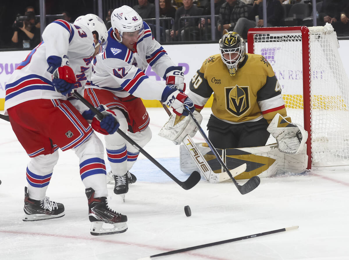 New York Rangers center Noah Laba (42) and New York Rangers left wing Conor Sheary (43) try to ...