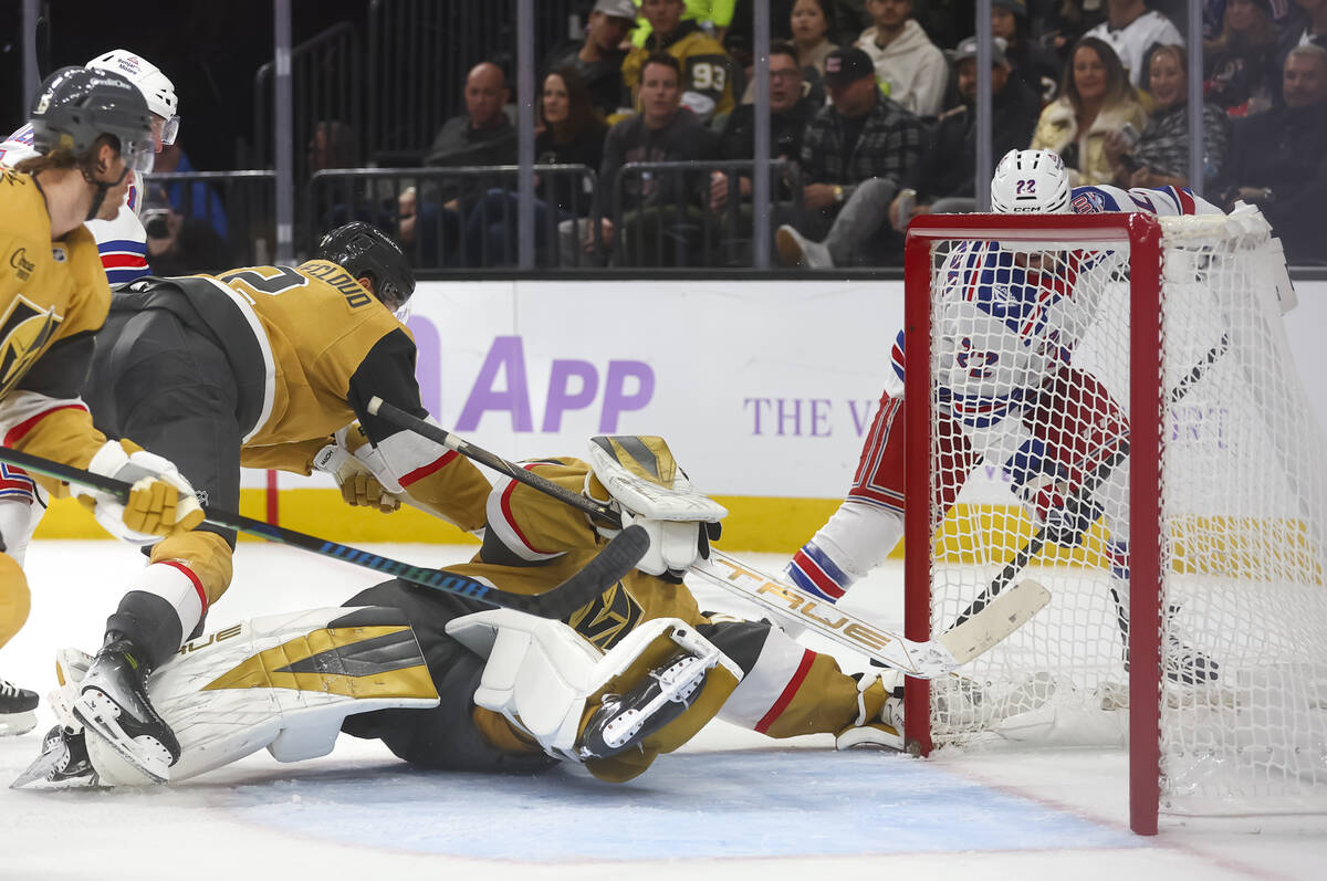 Golden Knights goaltender Akira Schmid (40) extends to stop the puck against New York Rangers c ...
