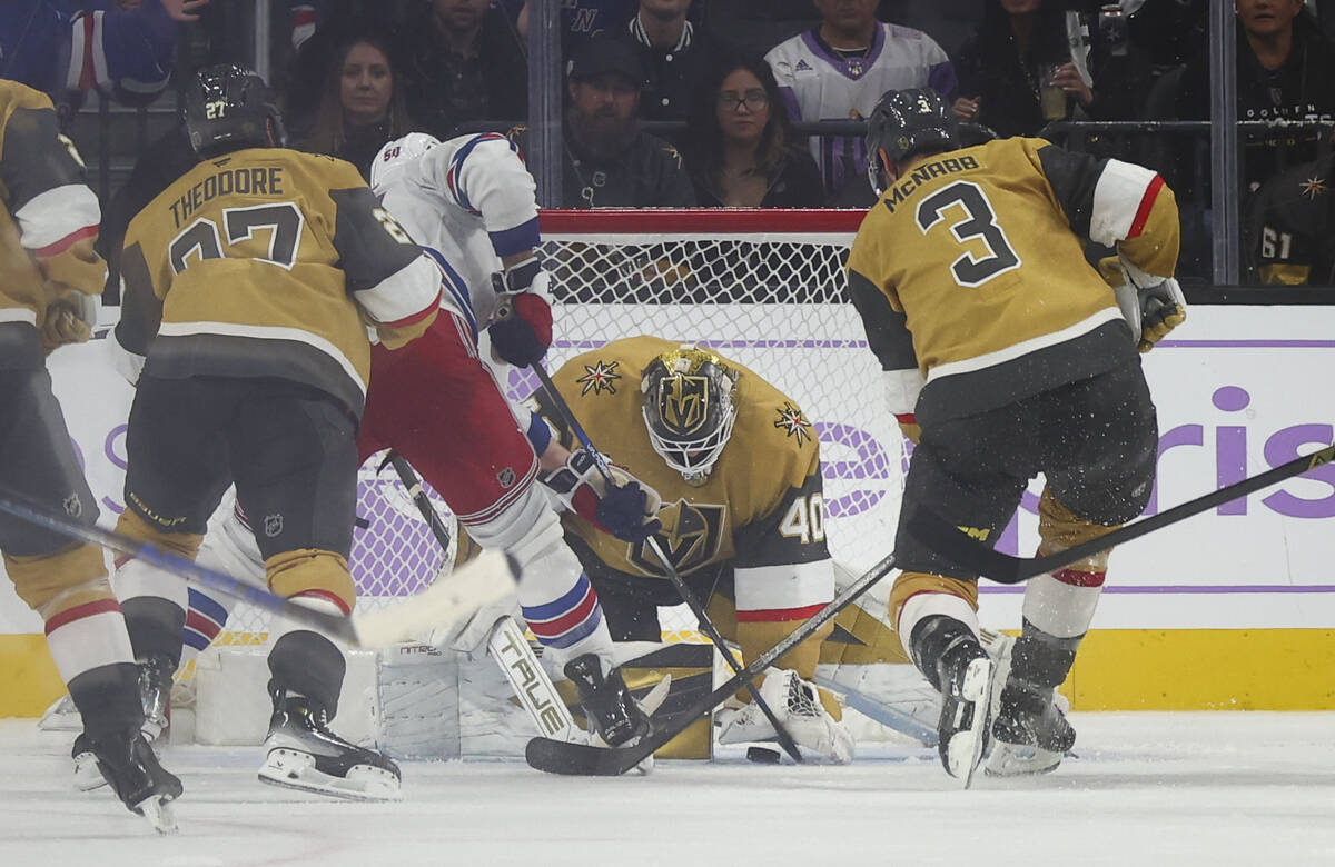 Golden Knights goaltender Akira Schmid (40) stops the puck against the New York Rangers in the ...