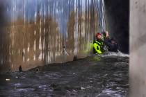 Las Vegas Firefighters team up to rescue a man from a flooded water channel named Vegas Creek a ...