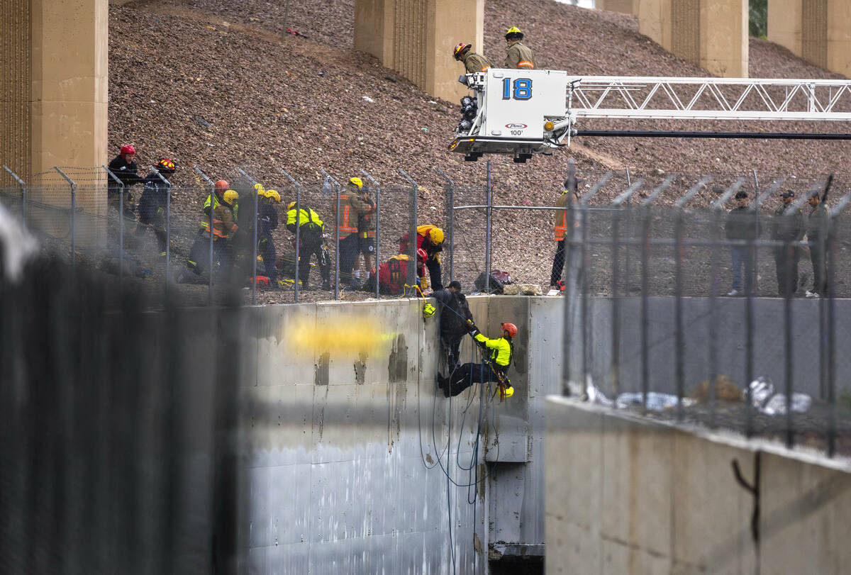 Las Vegas Firefighters team up to rescue a man from a flooded water channel named Vegas Creek a ...