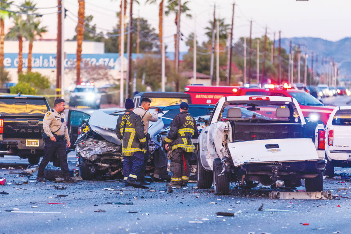 Metropolitan Police officers work with North Las Vegas firefighters as numerous vehicles are in ...
