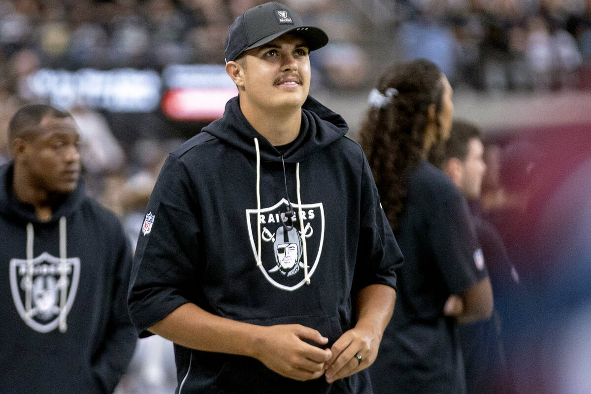 Raiders quarterback Aidan O'Connell walks the sideline during the first half of an NFL gam ...