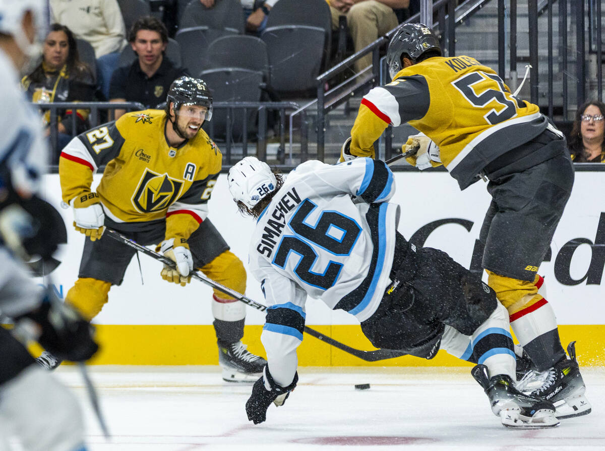 Golden Knights defenseman Shea Theodore (27) looks to pass as Utah Mammoth defenseman Dmitri Si ...