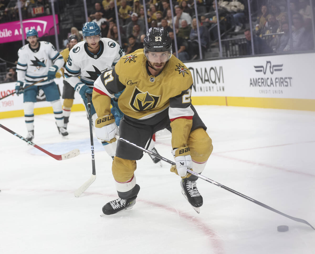 Golden Knights defenseman Shea Theodore (27) skates with the puck during the first period of an ...