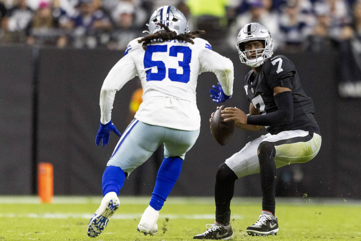 Raiders quarterback Geno Smith (7) is pursued by Dallas Cowboys defensive end James Houston (53 ...