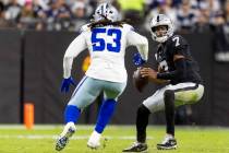 Raiders quarterback Geno Smith (7) is pursued by Dallas Cowboys defensive end James Houston (53 ...