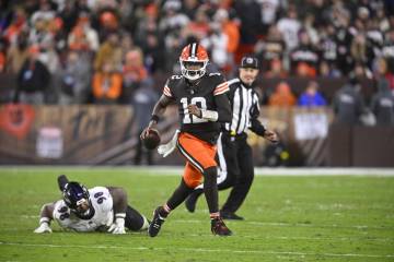 Cleveland Browns quarterback Shedeur Sanders scrambles during an NFL football game against the ...