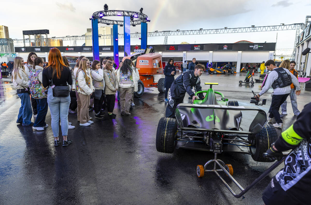 A group from the Girl Scouts of Southern Nevada watch as an F1 Academy race car is wheeled thro ...