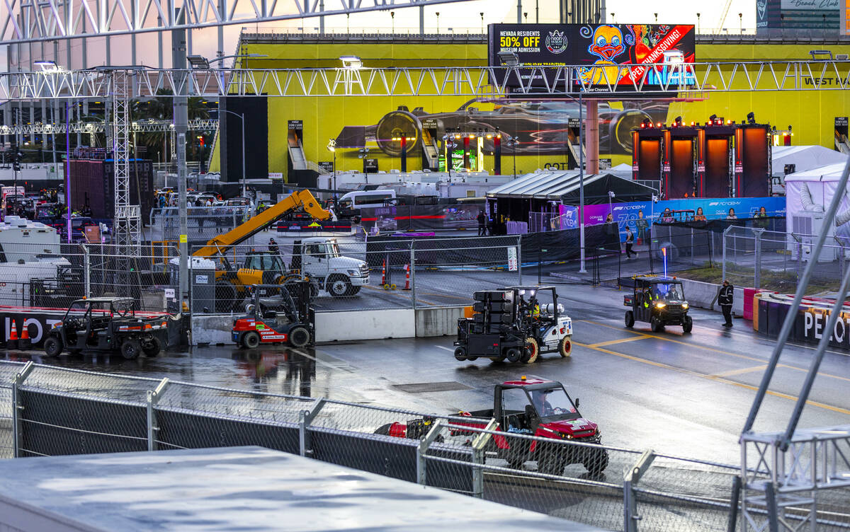 Crew members move about turn 3 while also drying the track following a rainstorm at the Las Veg ...