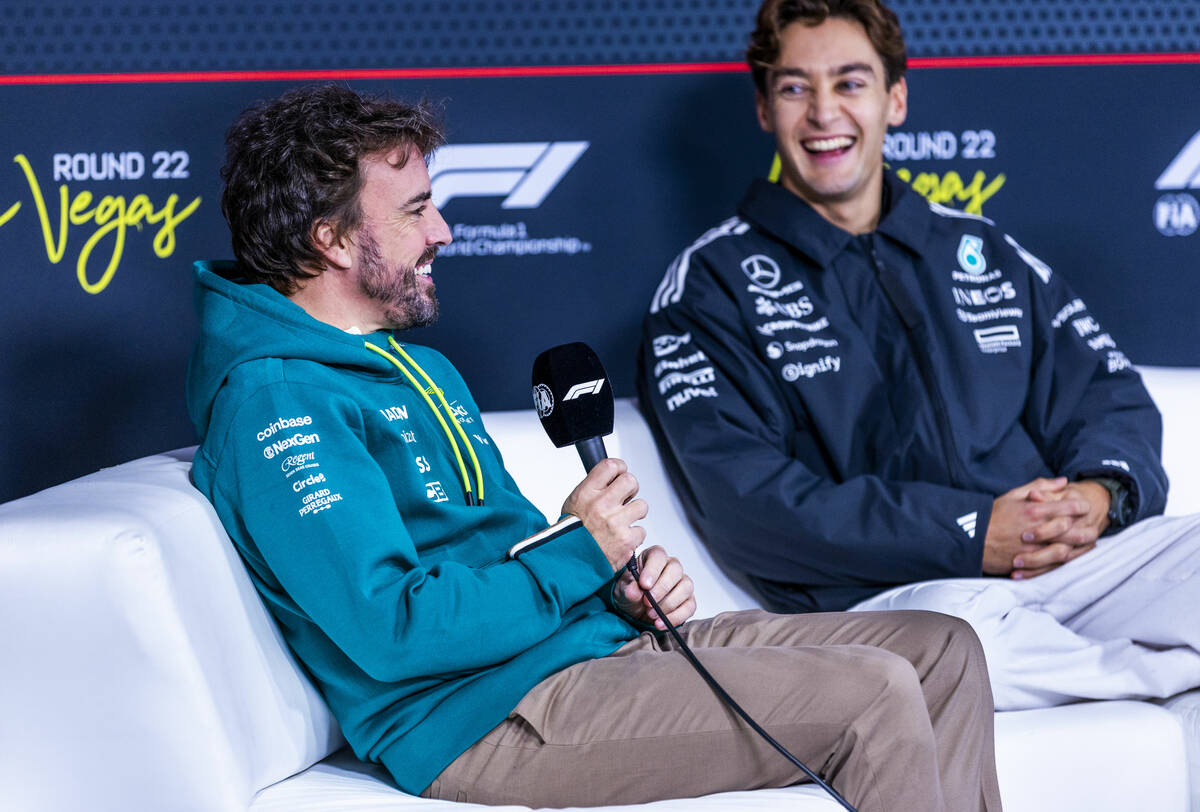 Aston Martin F1 Team driver Fernando Alonso and Mercedes F1 Team driver George Russell share a ...