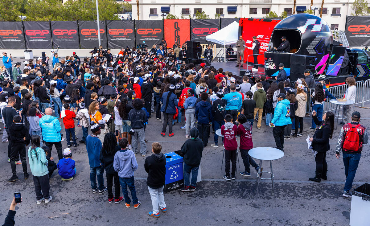Formula One driver Lewis Hamilton answers questions before a group of students during community ...