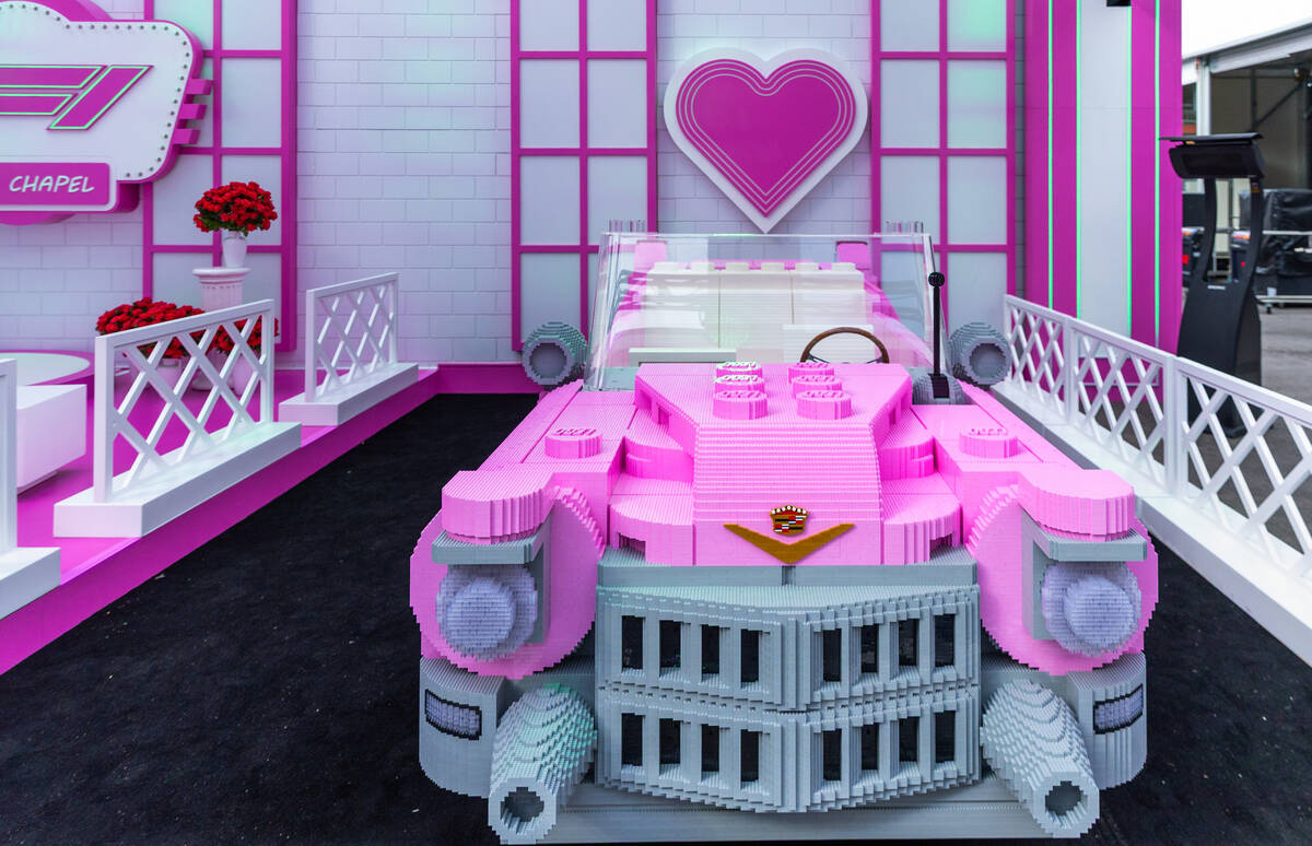 A Cadillac constructed from Legos is set within the F1 Neon Chapel adjacent to the F1 Pit Build ...