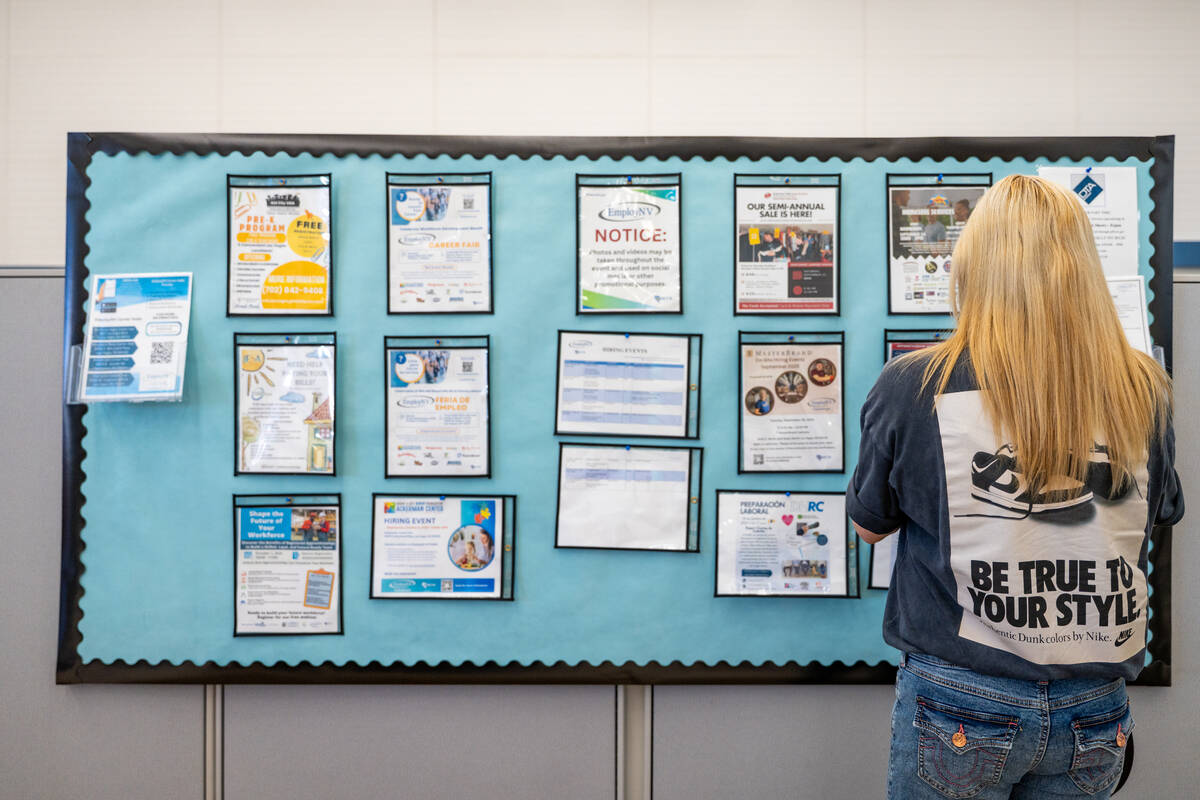 Jae Turney scans a job and resource board at EmployNV Career Hub in Las Vegas Sept. 29, 2025. T ...