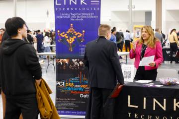Ishana Lennard, right, a technical recruiter at Link Technologies, talks to a job seeker during ...