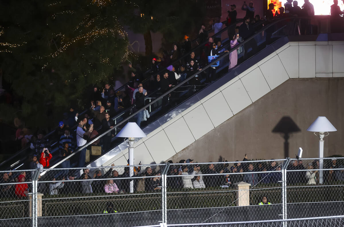 People watch the first practice of the Formula One Las Vegas Grand Prix auto race along the Las ...