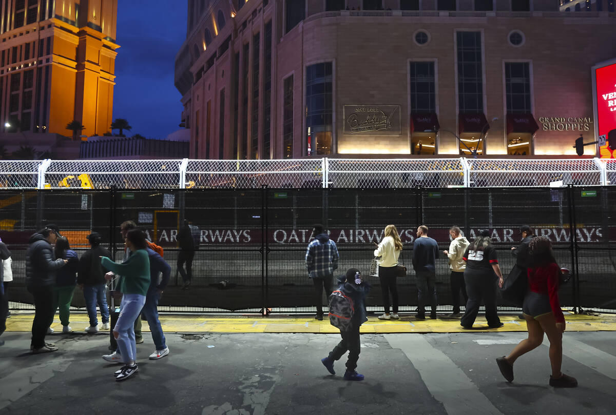 People watch the first practice of the Formula One Las Vegas Grand Prix auto race along the Las ...
