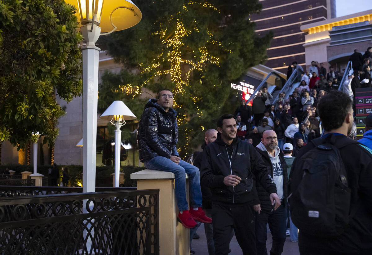 A man watches the first practice of the Formula One Las Vegas Grand Prix auto race along the La ...