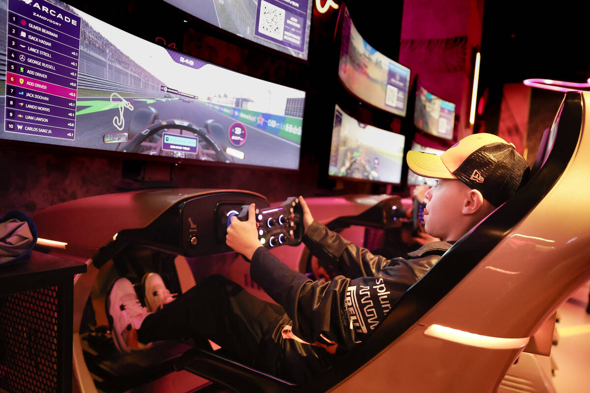 Jackson Kuhns drives an F1 simulator game in the F1 Arcade at Forum Shops Friday, November 21, ...