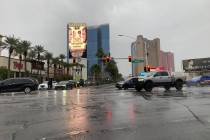 Motorists drive along Sahara Avenue and Las Vegas Boulevard during heavy rainfall on Saturday, ...