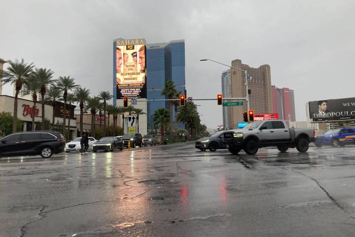 Motorists drive along Sahara Avenue and Las Vegas Boulevard during heavy rainfall on Saturday, ...