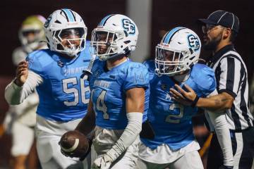 Sloan Canyon wide receiver Christian Rhodes celebrates a touchdown during a high school footbal ...