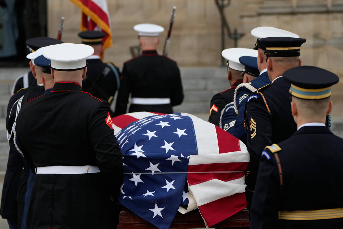 A joint services body bearer team carries the flag-draped casket of former Vice President Dick ...