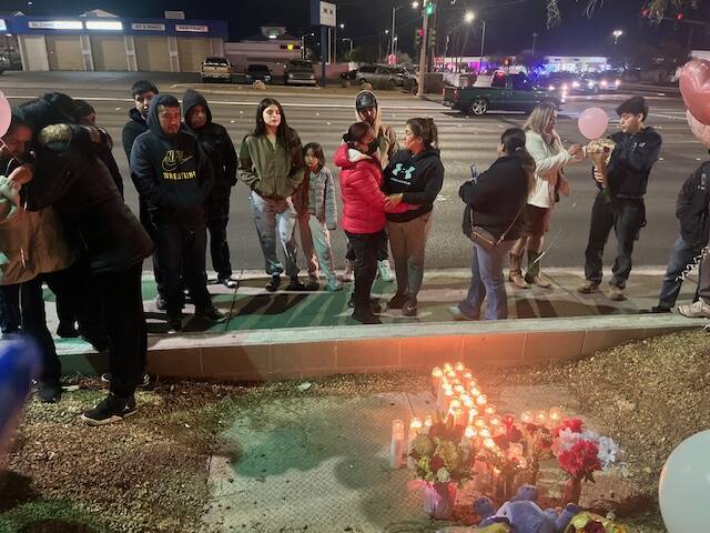 Family of crash victim Adilene Duran Rincon gather alongside Cheyenne Avenue, near the site of ...