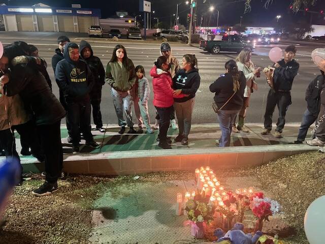 Family of crash victim Adilene Duran Rincon gather alongside Cheyenne Avenue, near the site of ...