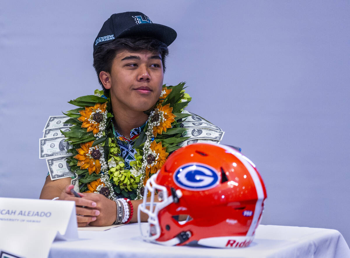 Bishop Gorman quarterback Micah Alejado listens to player introductions during a National Signi ...