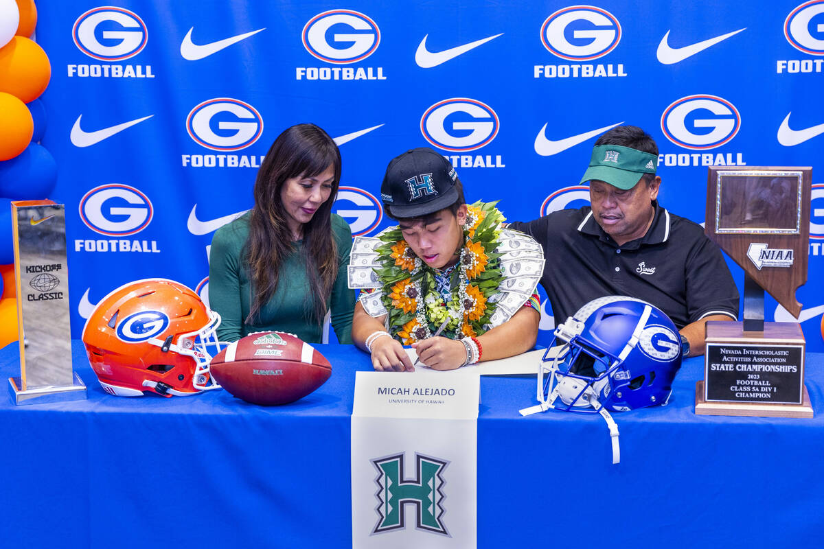 Bishop Gorman player Micah Alejado and family with a commitment letter to the University of Haw ...