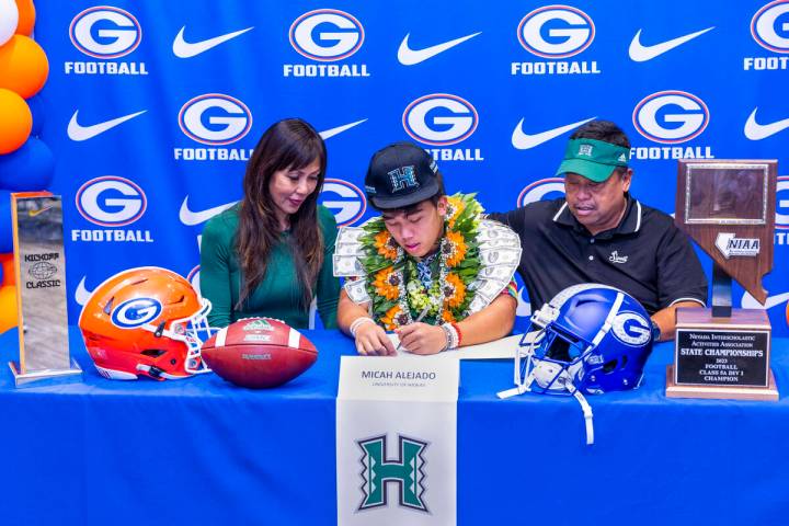 Bishop Gorman player Micah Alejado and family with a commitment letter to the University of Haw ...