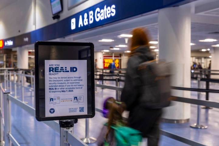 Travelers make their way to a TSA security checkpoint in Terminal One as the Real ID act is bei ...