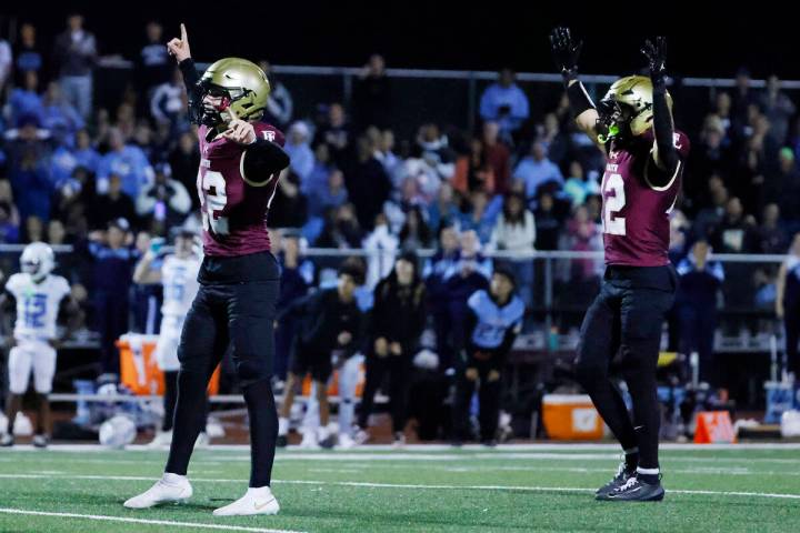 Faith Lutheran kicker Liam Radke, left, and wide receiver Aipa Kuloloia celebrate after Radke ...